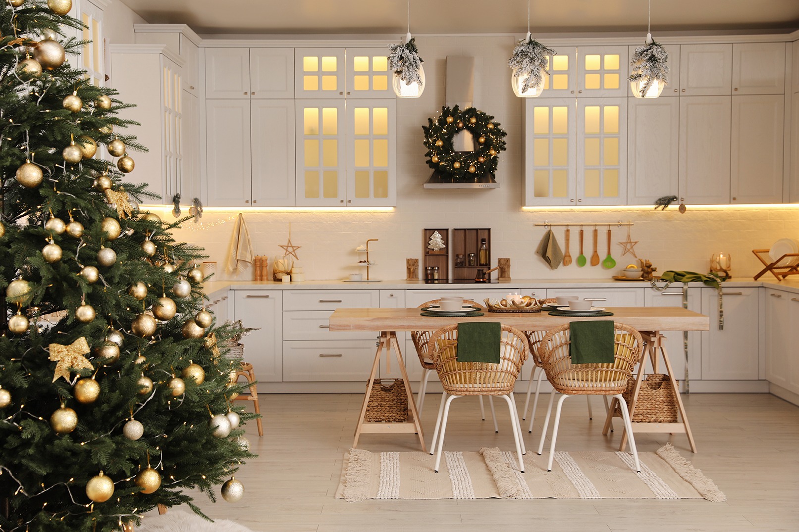 Picture of a beautiful white kitchen with a lit Christmas tree and wreath