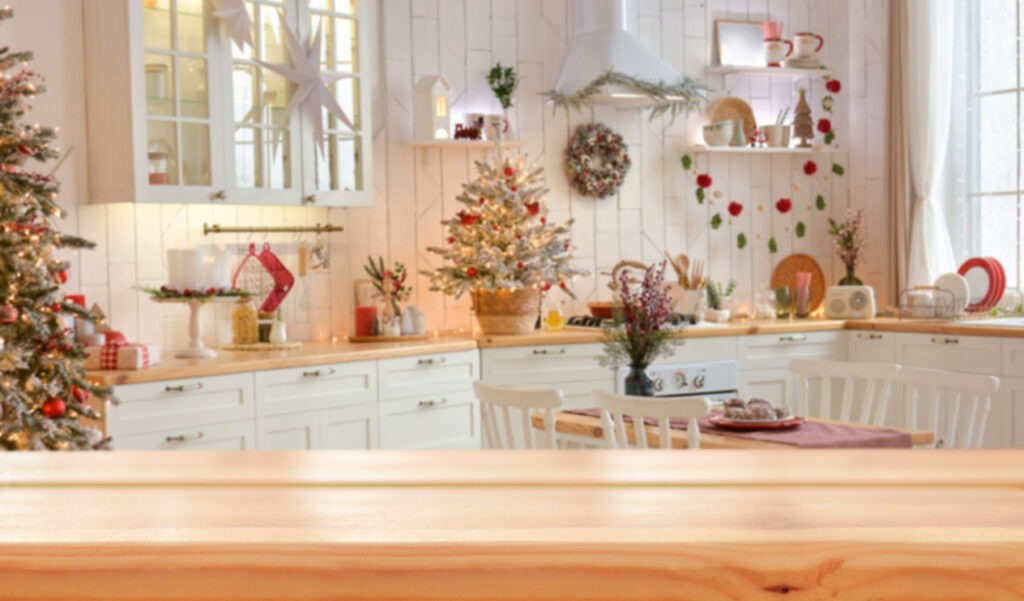 Picture of a beautiful white kitchen decorated with many Christmas decorations.